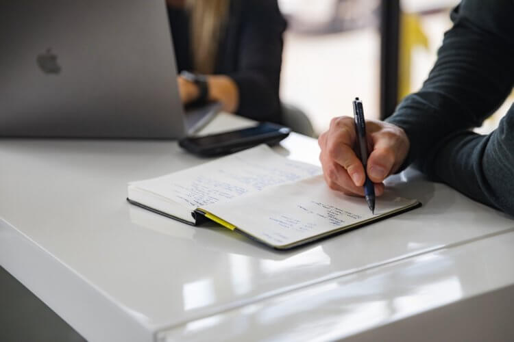 A photo of a lawyer sitting at a desk writing a checklist on law firm data encryption