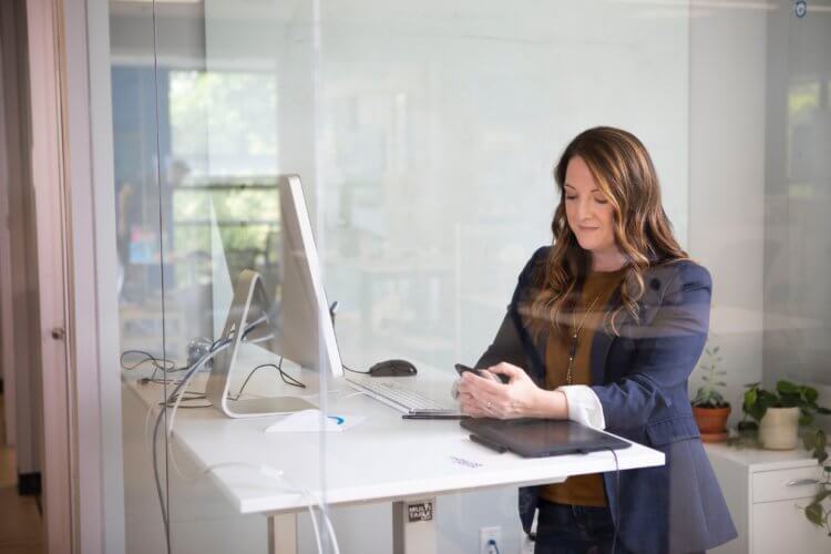 Photo of a lawyer looking for legal malpractice insurance providers on her phone