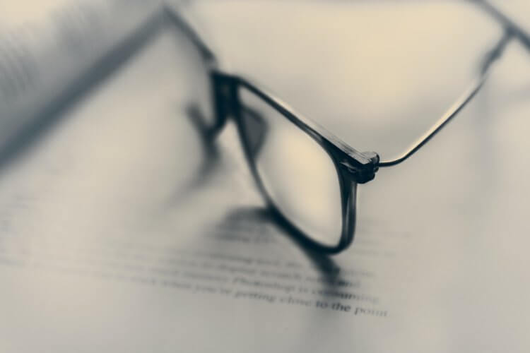 Photo of eyeglasses on top of documents, representing legal malpractice insuranec