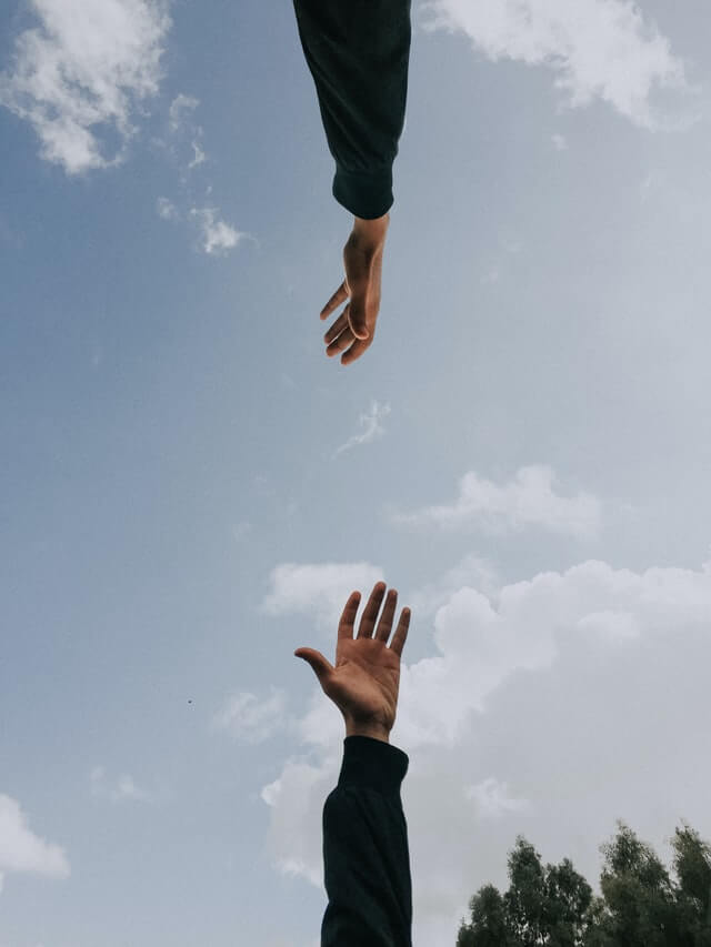 photo of two hands reaching out