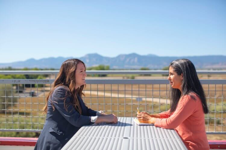 Reopening your law office safely: Image of two women having a business meeting outdoors