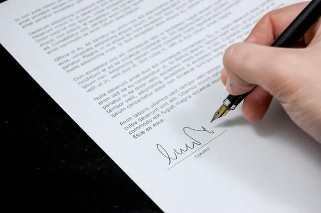 person signing a letter