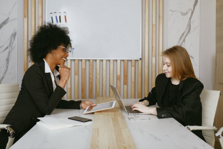 A photo of two lawyers sitting across from one another at a table