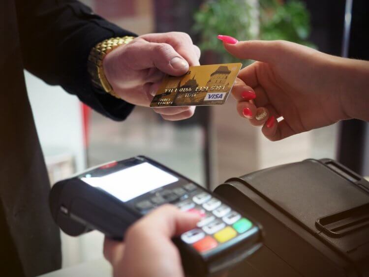 A photo of someone using a credit card to pay for legal fees made possible by payment processing technology
