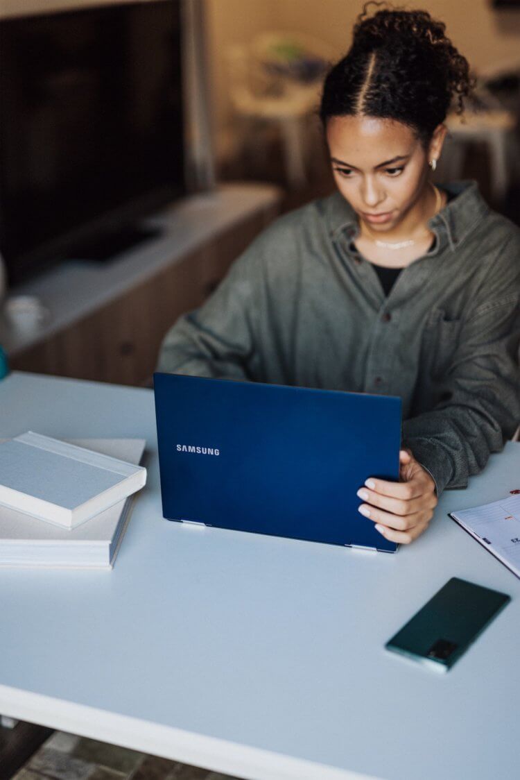 A photo of a paralegal on her laptop reading a paralegal newsletter