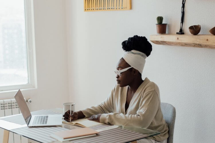 Person writing in journal at desk