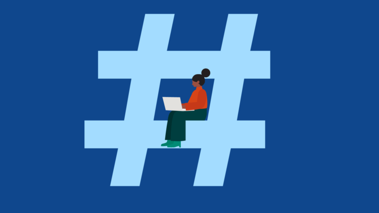 Woman sitting in a hashtag with a laptop