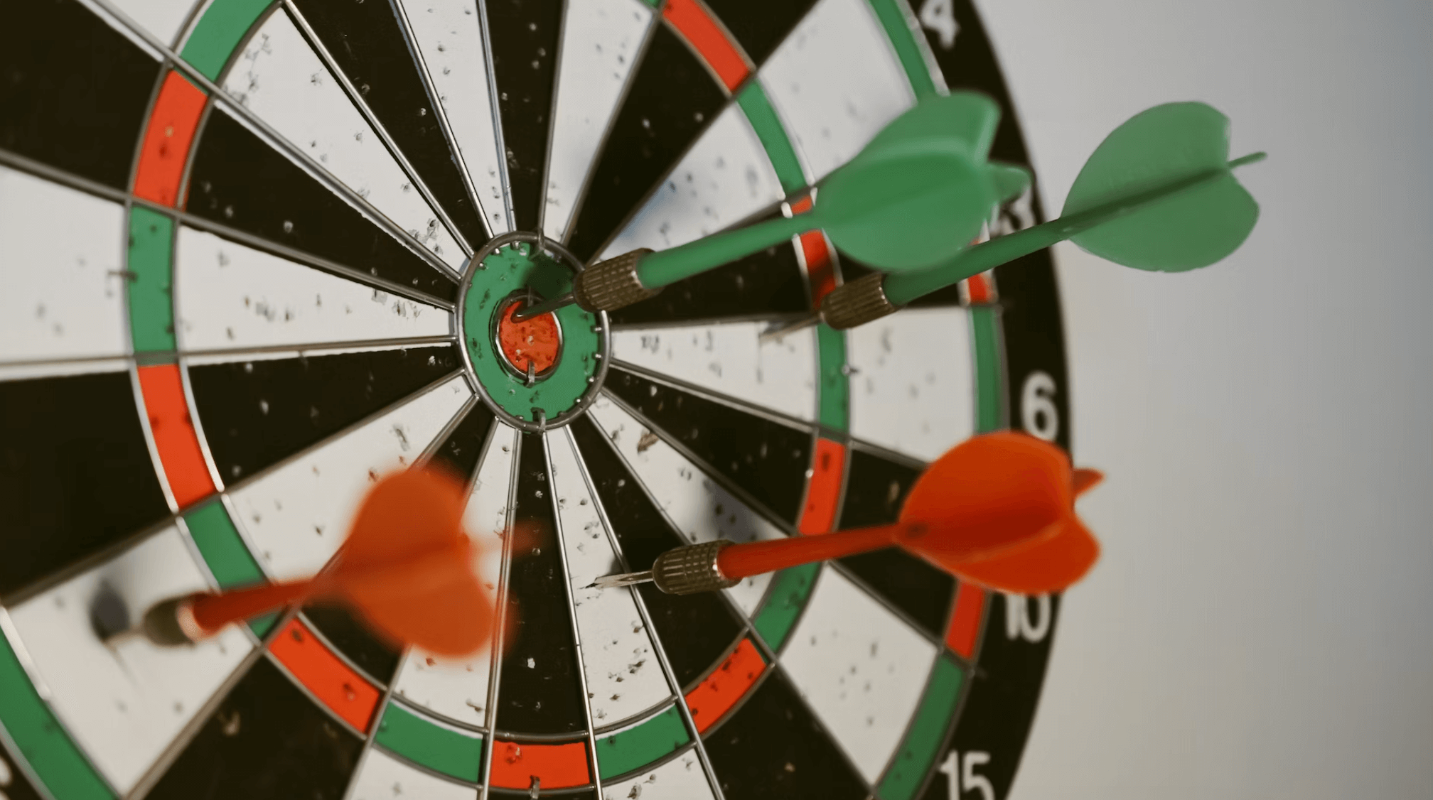 Dart board with darts on the target